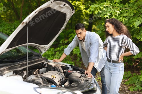 Preview: Frustrated middle-eastern couple having broken car while countryside trip
