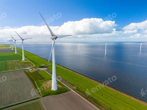 Preview: A wind farm generates clean energy in the middle of a vast Dutch lake, with rows of windmill