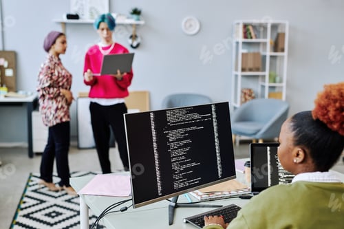 Preview: Close up of black young woman writing code and using computer
