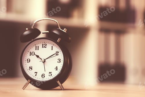Preview: Classic alarm clock showing time during working hours in office