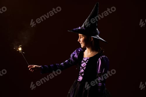 Preview: Girl burning sparkler on Halloween night