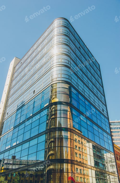 Preview: low angle view of modern office building against blue sky, oslo, norway