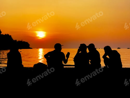 Preview: Silhouette of People having a chat on the beach during sunset