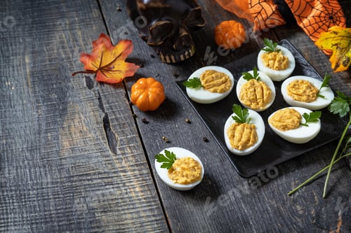 Preview: Halloween funny idea for party food. Halloween creative set stuffed eggs pumpkin.