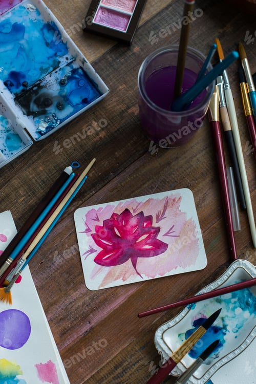 Preview: Watercolor Flower Painting and Painting Supplies on Table