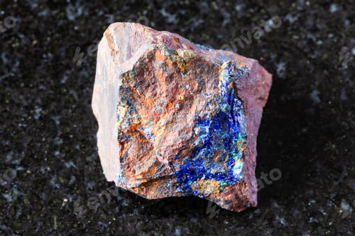 Preview: sample of raw zarinite mineral on black granite