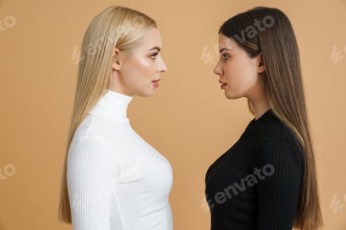 Preview: Beautiful two women looking at each other while posing on camera