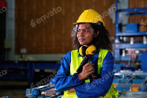 Preview: Portrait Female engineering operator wear safety uniform Quality control checking process in factory