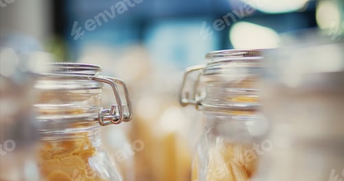 Preview: Selective focus of reusable jars filled with cereals and pasta