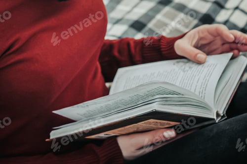 Vista previa: Young woman holding an open book in her hands. Reading, lifestyle