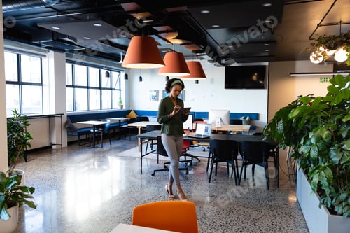 Preview: African american young businesswoman using smart phone in creative office