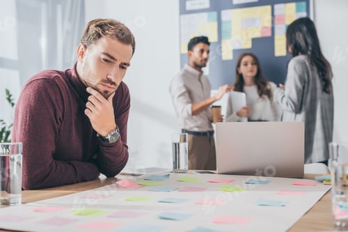 Preview: selective focus of pensive businessman touching face
