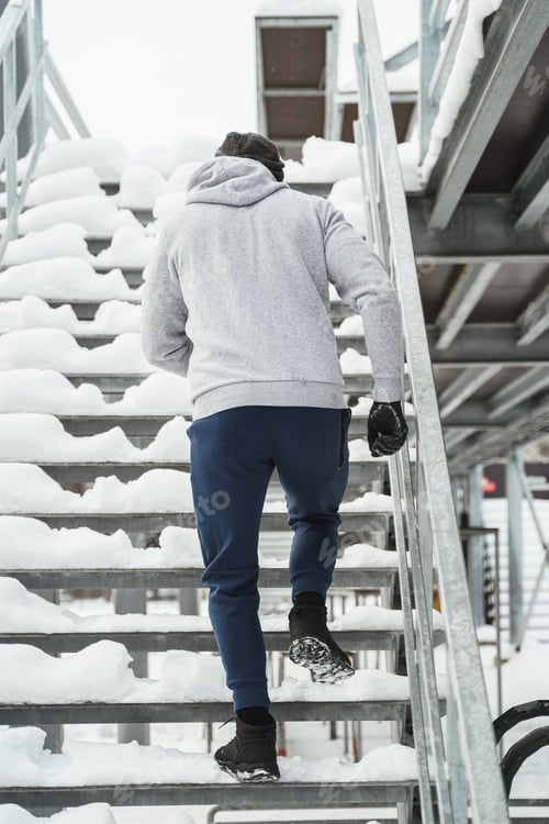 Preview: Athletic man running on stairs during his winter workout