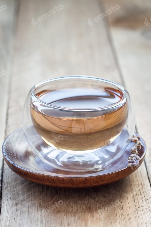 Preview: Herbal lavender tea in oriental glass cup, vertical, copy space