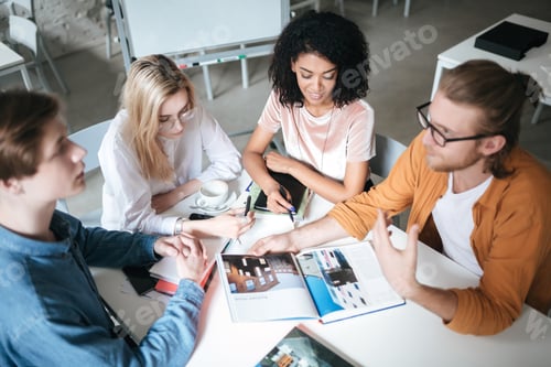 Preview: Portrait of young people sitting in office discussing project