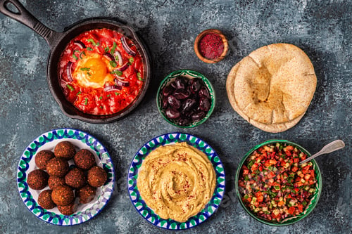 Preview: Falafel, hummus, shakshuka, Israeli salad - traditional dishes of Israeli cuisine.