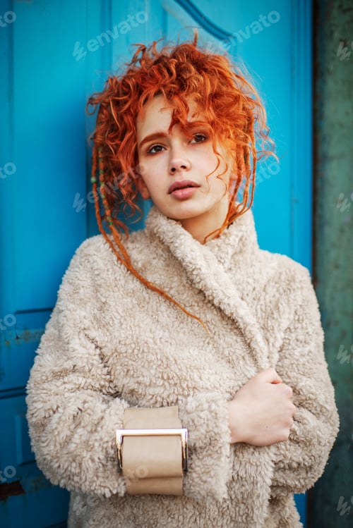 Preview: Beautiful red-haired woman next to the blue door.