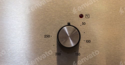 Preview: Close-up hand setting cooking mode or temperature on oven