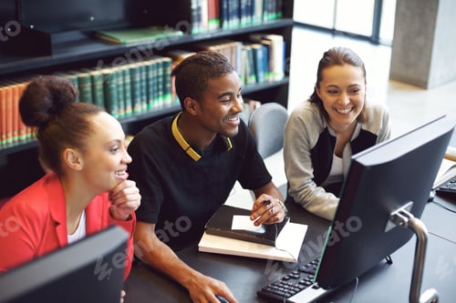 Preview: Students working on computer in a college library