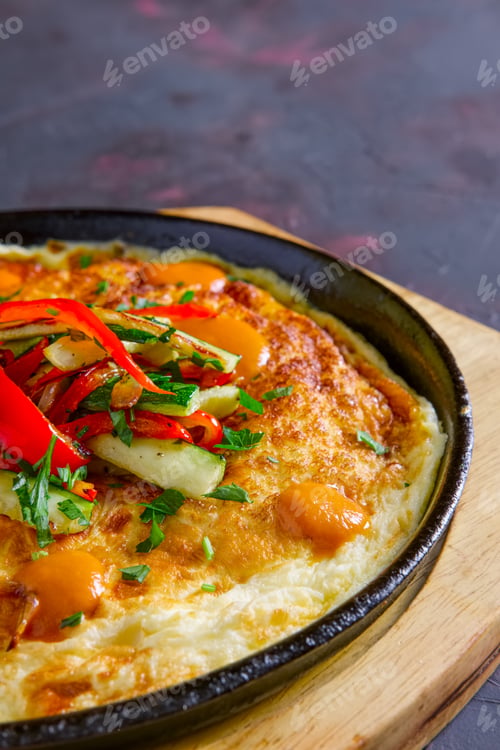 Preview: Vegetarian omelette with vegetables in cast iron pan