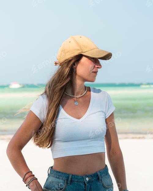 Preview: Tourist wearing cap enjoying tropical beach in zanzibar, tanzania