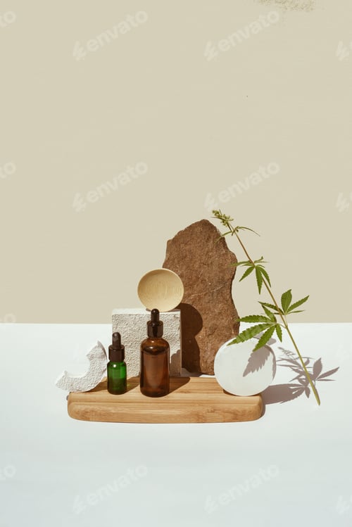 Preview: Various glass bottles with CBD oil, THC tincture and hemp leaves on beige background. minimalism