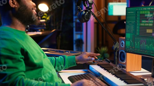 Preview: Man Composing Music Using Audio Software at Night