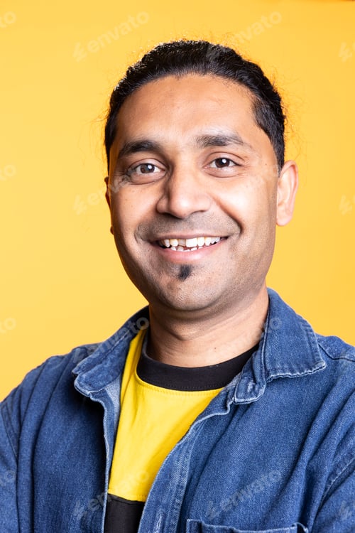 Preview: Portrait of jolly indian man smiling and posing with arms crossed
