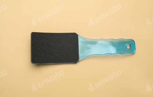 Preview: Light blue foot file on beige background, top view. Pedicure tool