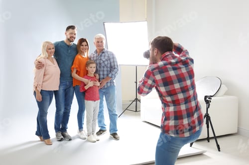 Preview: Professional photographer taking photo of family in studio