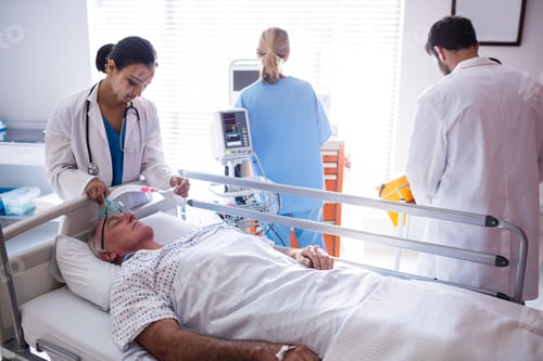 Preview: Team of doctors putting oxygen mask on patient face