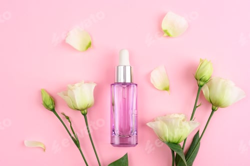 Preview: Purple cosmetic bottle and white eustoma flowers on pink background. Top view, flat lay