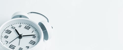Preview: Close-up of a white alarm clock on a white background, ten o'clock. Blank space for text