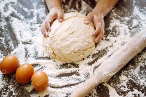 Preview: Children hands kneading dough on wooden table. Easter baking preparation. Cookies for Christmas.