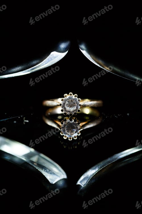 Preview: Gold wedding ring on black glass