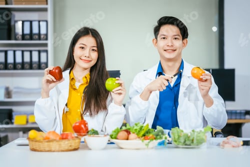 Preview: Two nutritionists,female and male, work in a hospital, analyzing vegetable and fruit salads