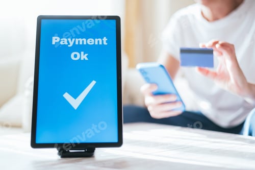 Preview: Person completing secure online payment using smartphone and credit card
