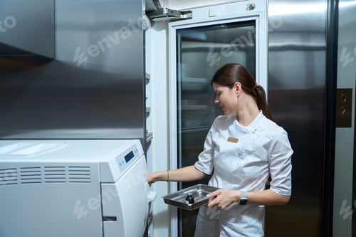 Preview: Side view of nurse puting medicines and preparations in a special refrigerator