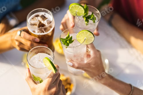 Preview: Group of people celebrating toasting with cocktails