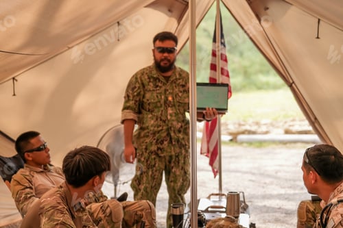 Preview: Confident man in uniform pointing at computer screen and explaining something