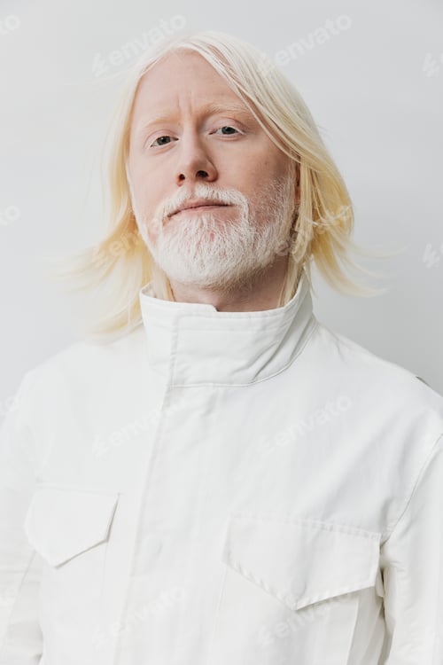 Preview: Portrait of a confident man with long white hair and a beard, dressed in a stylish white outfit