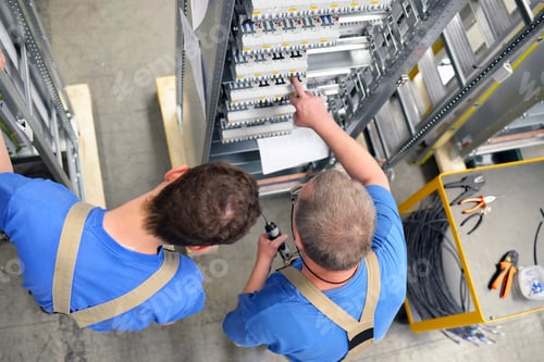 Preview: Two workers in a switchboard construction factory