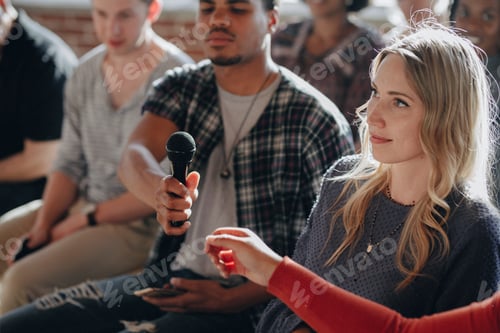 Preview: Man handing a microphone to a woman