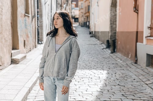 Preview: Young girl walks around the city in the spring