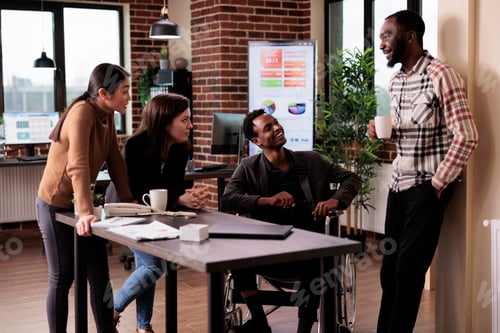 Preview: Business partners laughing together in disability friendly office