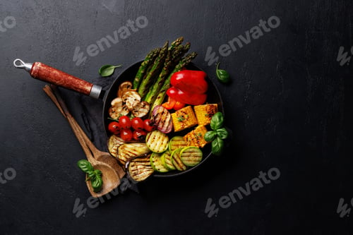 Preview: Assorted grilled vegetables on a frying pan, showcasing a colorful and healthy meal