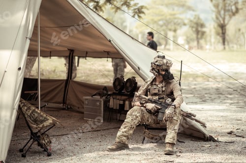 Preview: Soldiers in camouflage uniforms planning on operation in the camp