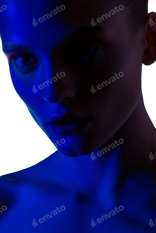 Preview: Beauty portrait of sensual young woman in blue neon light on white background