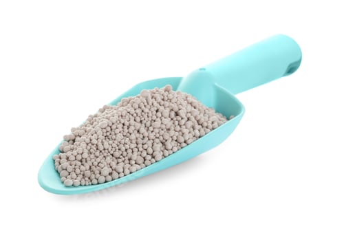 Preview: Scoop with chemical fertilizer isolated on white. Gardening time