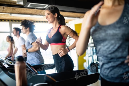 Preview: Fit people running in machine treadmill at fitness gym